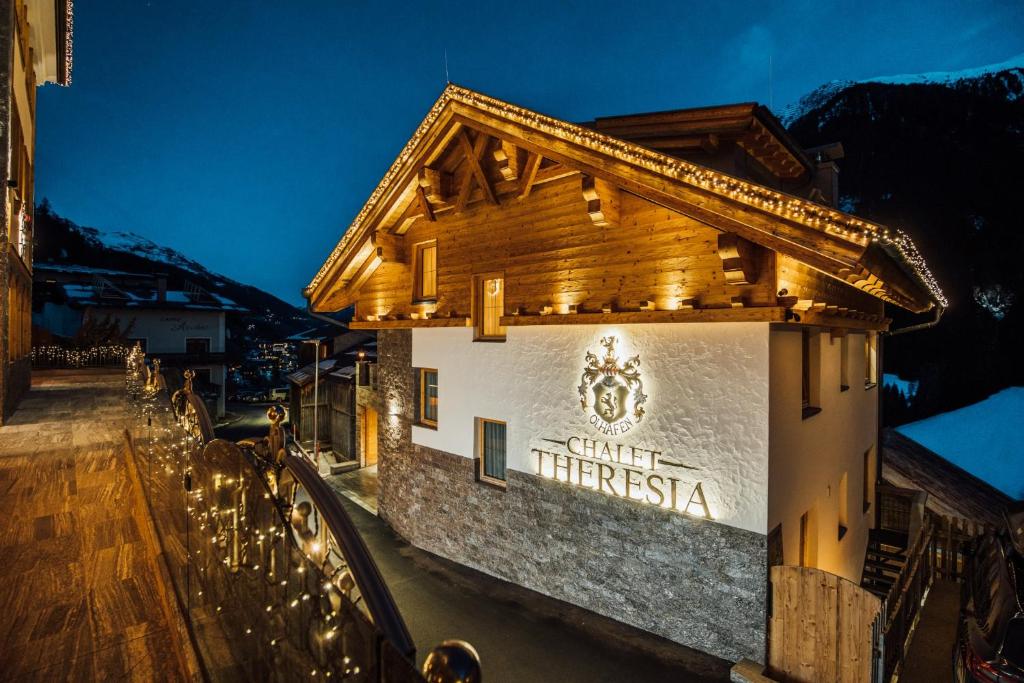 a sign on the side of a building with lights at Chalet Theresia in Kappl