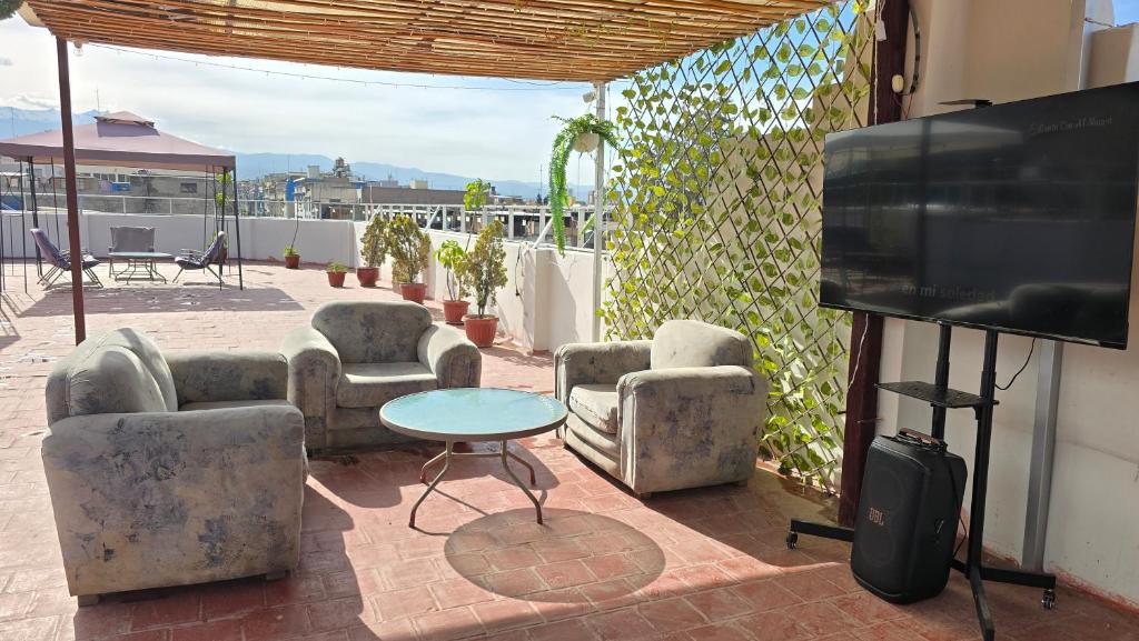 a living room with couches and a flat screen tv at HOTEL BOUTIQUE TerrazaINN in Arequipa