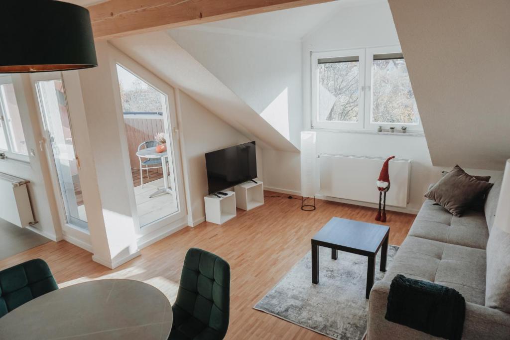 a living room with a couch and a table at FeWo Kibo Kupferberg in Kirchheimbolanden
