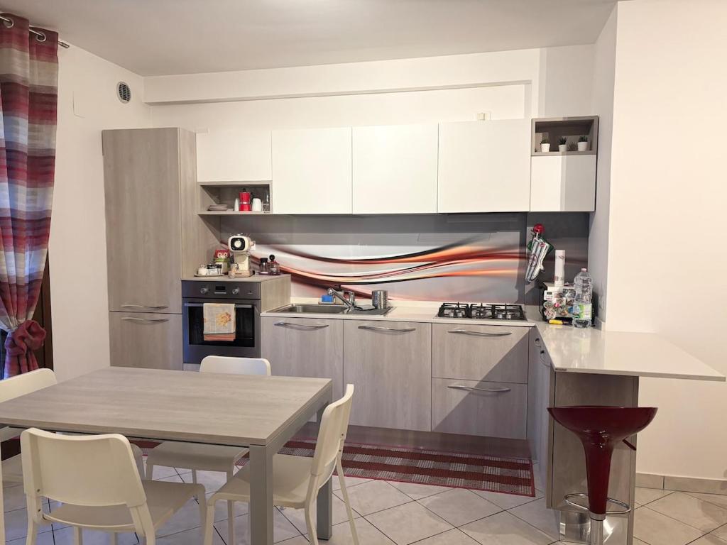 a kitchen with a table and a table and chairs at Home 14 in Tortoreto Lido