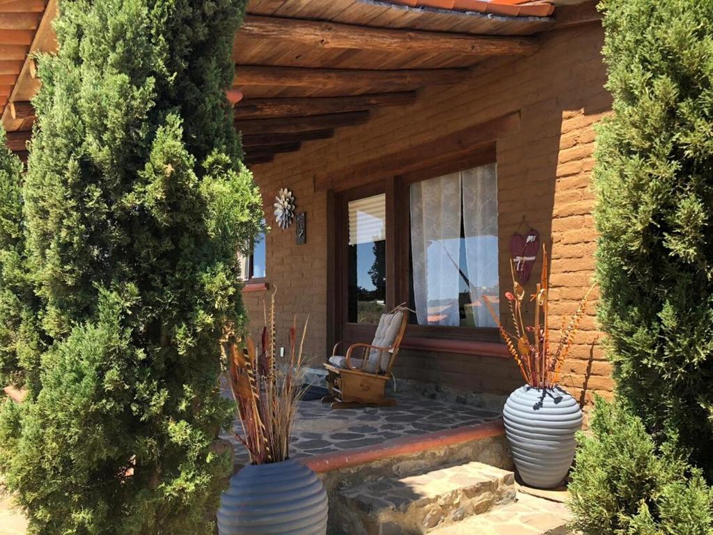 a porch of a house with two white vases at Happy Trails in San Antonio