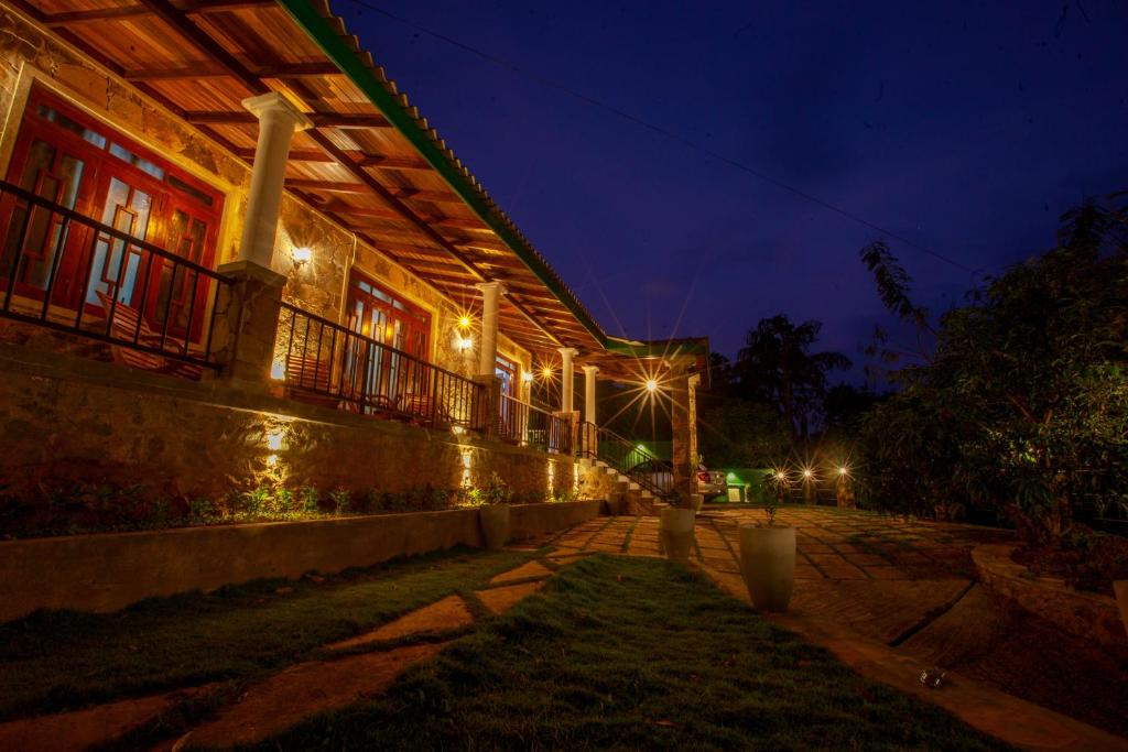 a building with lights on the side of it at night at Meadow Villa - Ella in Ella