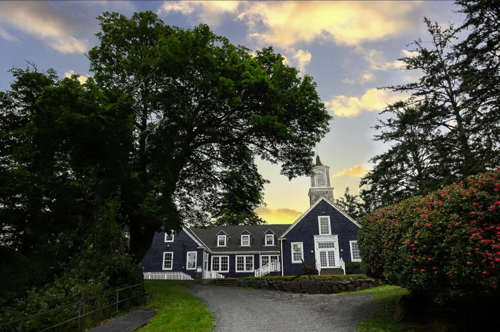 a large black and white house with a steeple at Inn at Harbour Village in Ilwaco