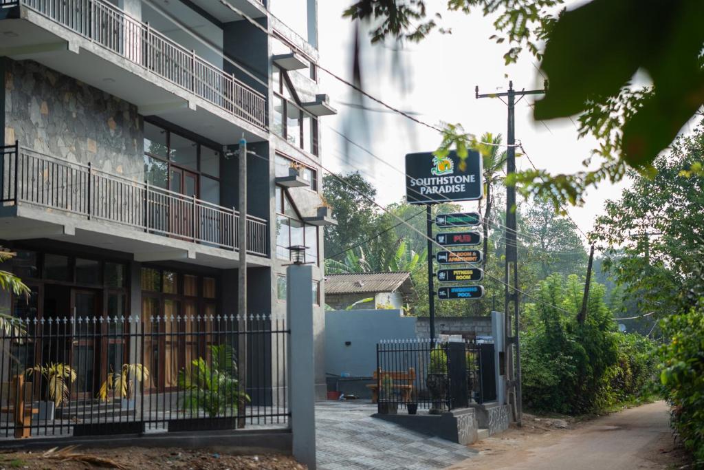 a street sign in front of a building at SouthStone Paradise in Balapitiya