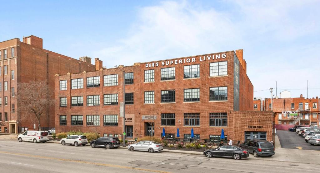 a large brick building with cars parked in a parking lot at 2125 Superior Living in Cleveland