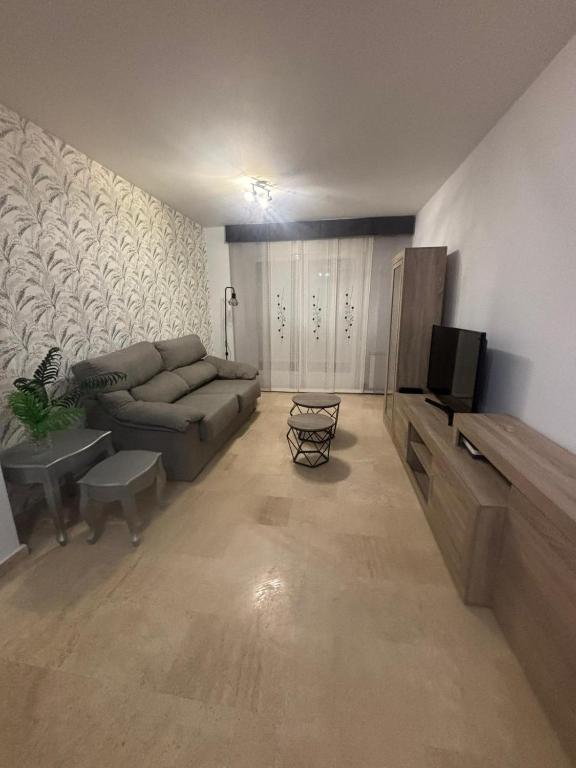 a living room with a couch and a television at ElFogaril in Teruel