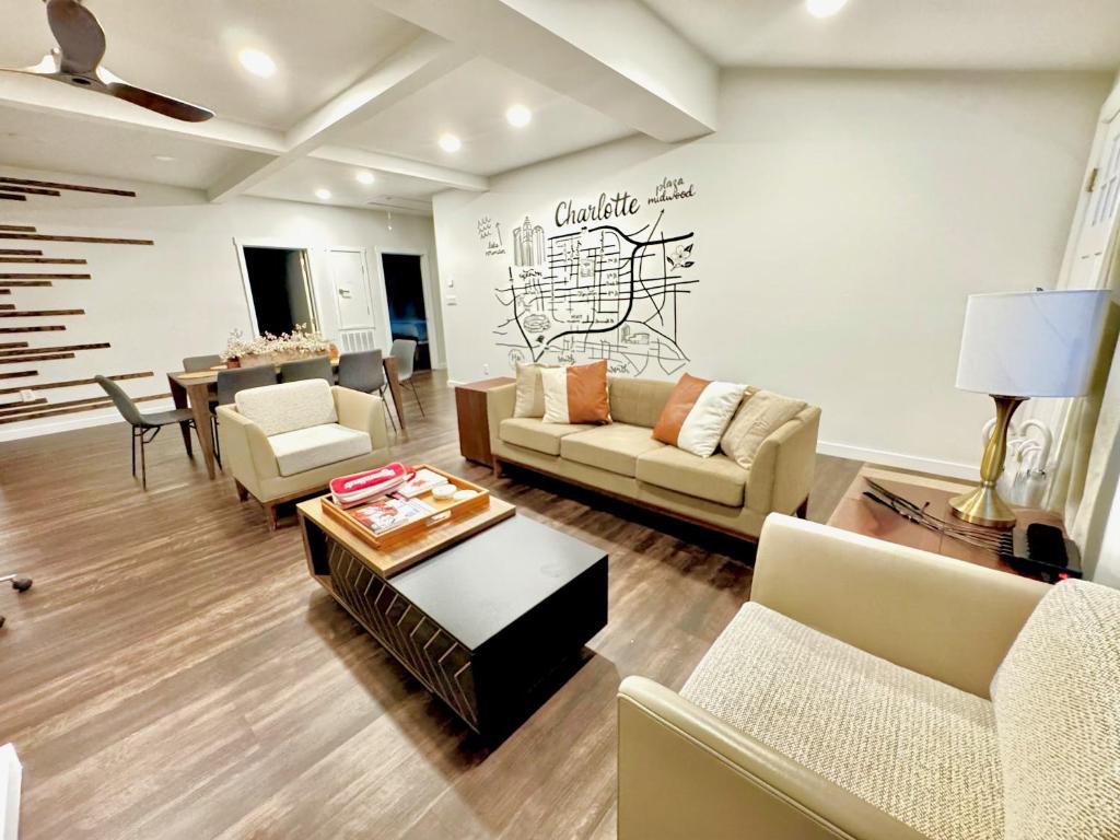 a living room with couches and a table at HPThe Abode Downtown Bojangles Dogs Welcome Yard in Charlotte
