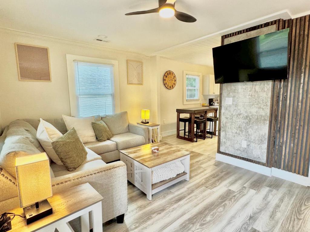 a living room with a couch and a flat screen tv at HPThe Haus BOFA Stadium Spectrum Bojangles Dogs in Charlotte