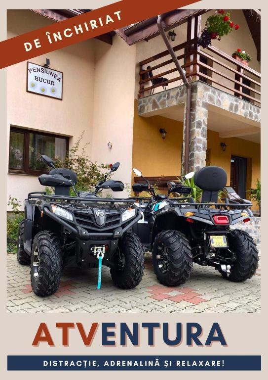 an atv and a quad bike parked in front of a building at Pensiunea Bucur in Dămuc
