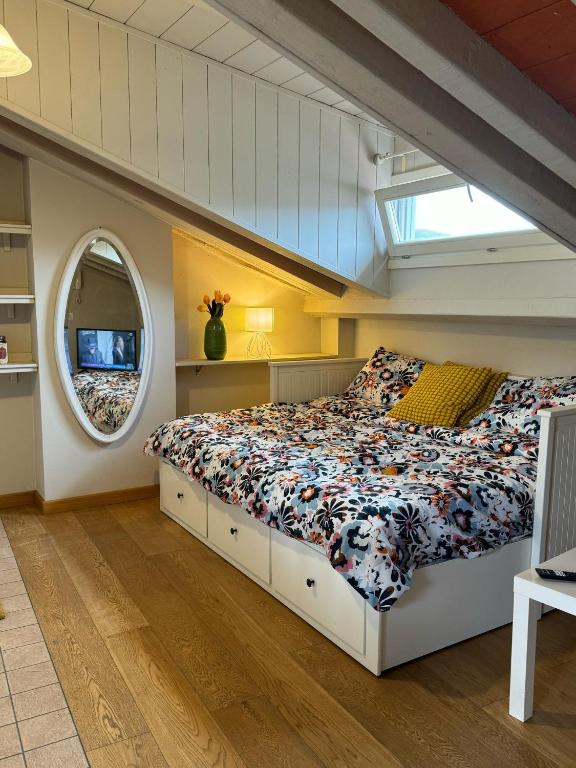 a bedroom with a bed in a room with a window at La casa sui tetti di Varzi in Varzi