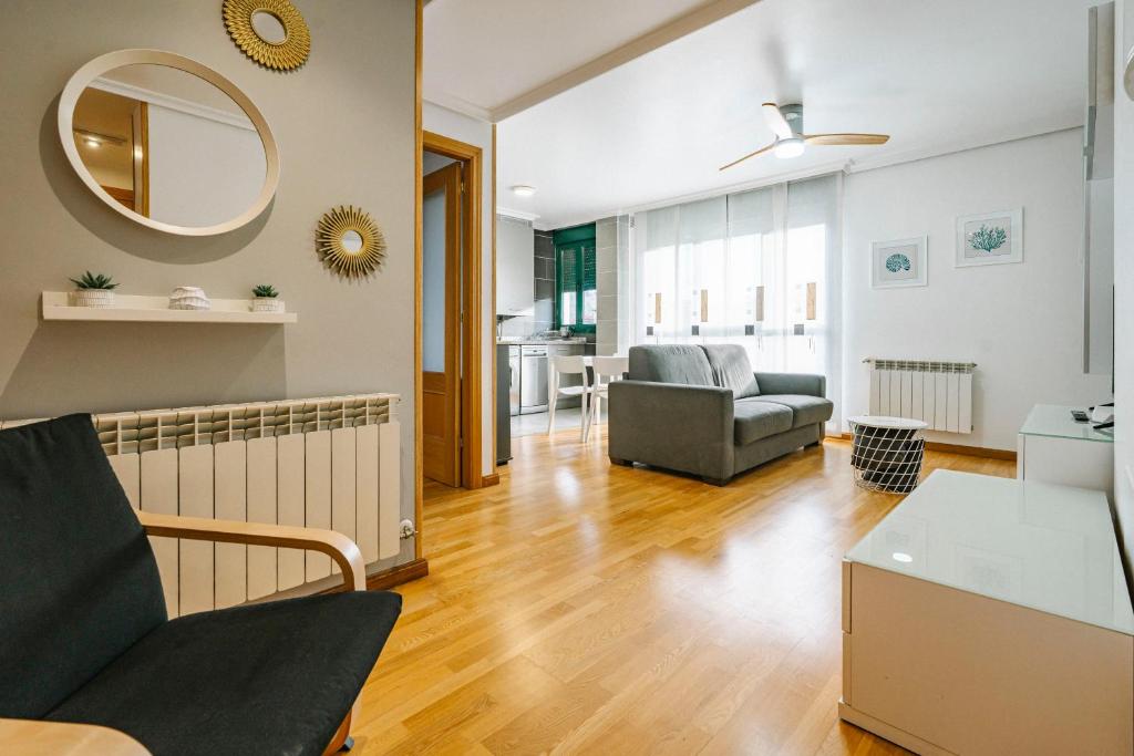 a living room with a couch and a mirror at adrimarcangas in Cangas de Onís