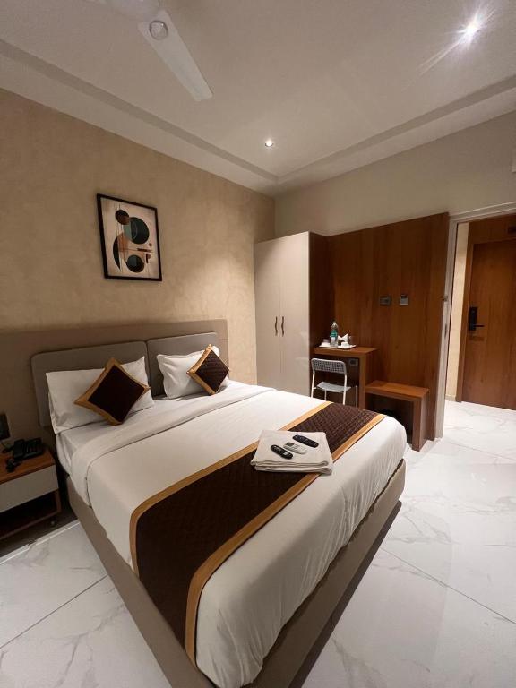 a bedroom with a large bed in a room at Hotel Liora Suites in Bangalore