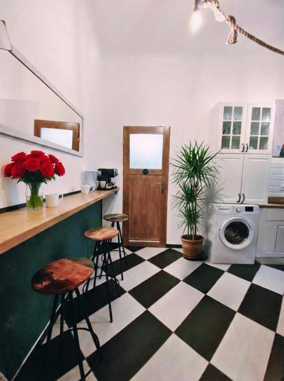 a kitchen with a black and white checkered floor at Topolove Rooms & Apartments in Krakow