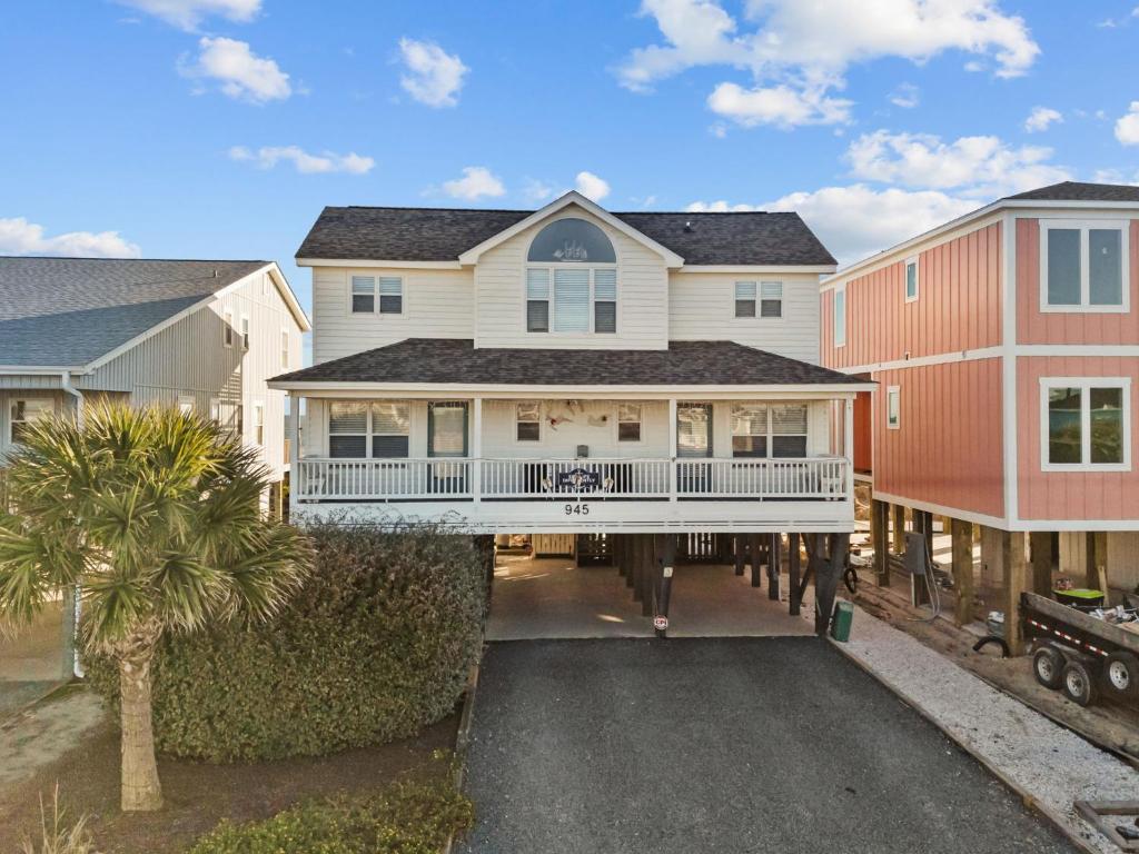 an aerial view of a house with a balcony at Oceanfront luxury, private pool & beach access! in Holden Beach