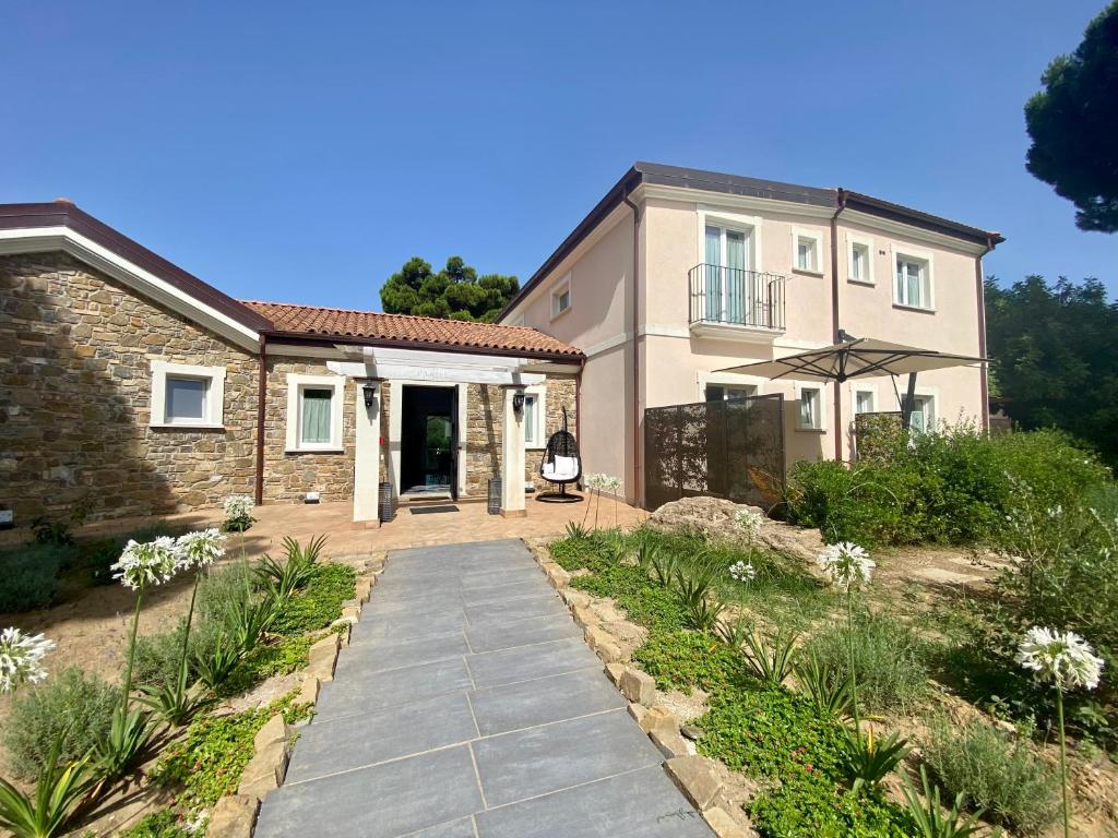 a house with a walkway in front of it at Tenuta Bellelli in Castellabate