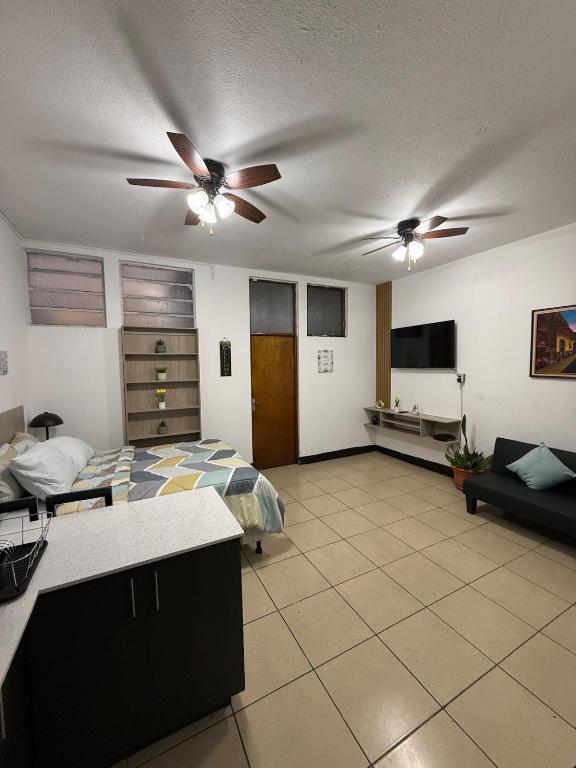 a bedroom with a bed and a ceiling fan at AeroloftGT in Estación Pamplona