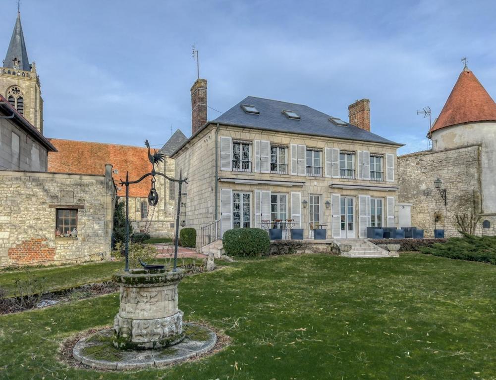 a large stone house with a yard in front of it at Maison de Charme a Rémy in Rémy
