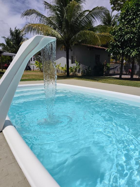 a water fountain in a swimming pool at Mangut in São Miguel dos Milagres