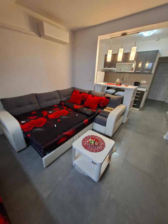a living room with a couch and a table at Studio apartman Laura in Vinkovci