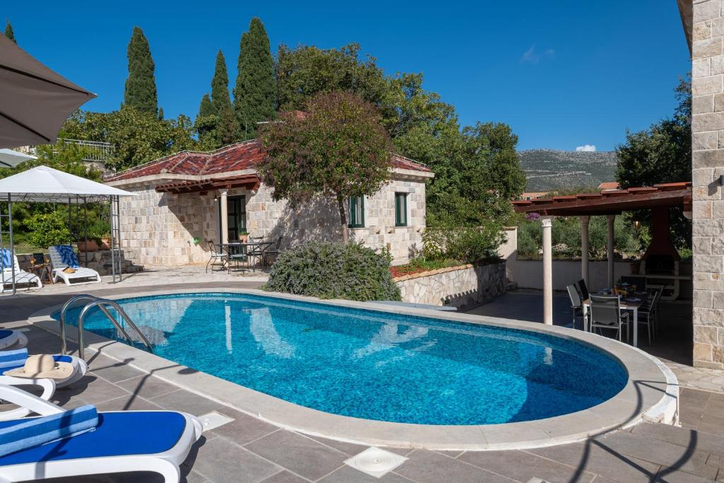 a swimming pool in front of a house at South Estate in Čilipi
