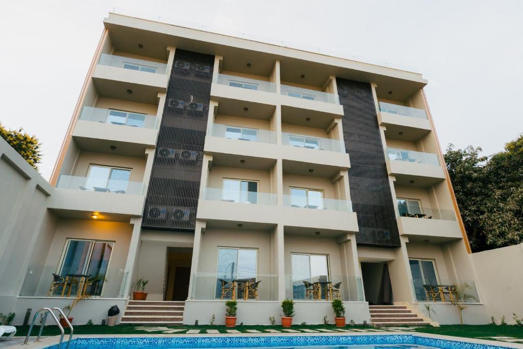 an apartment building with a swimming pool in front of it at The View Luxor hotel in Luxor