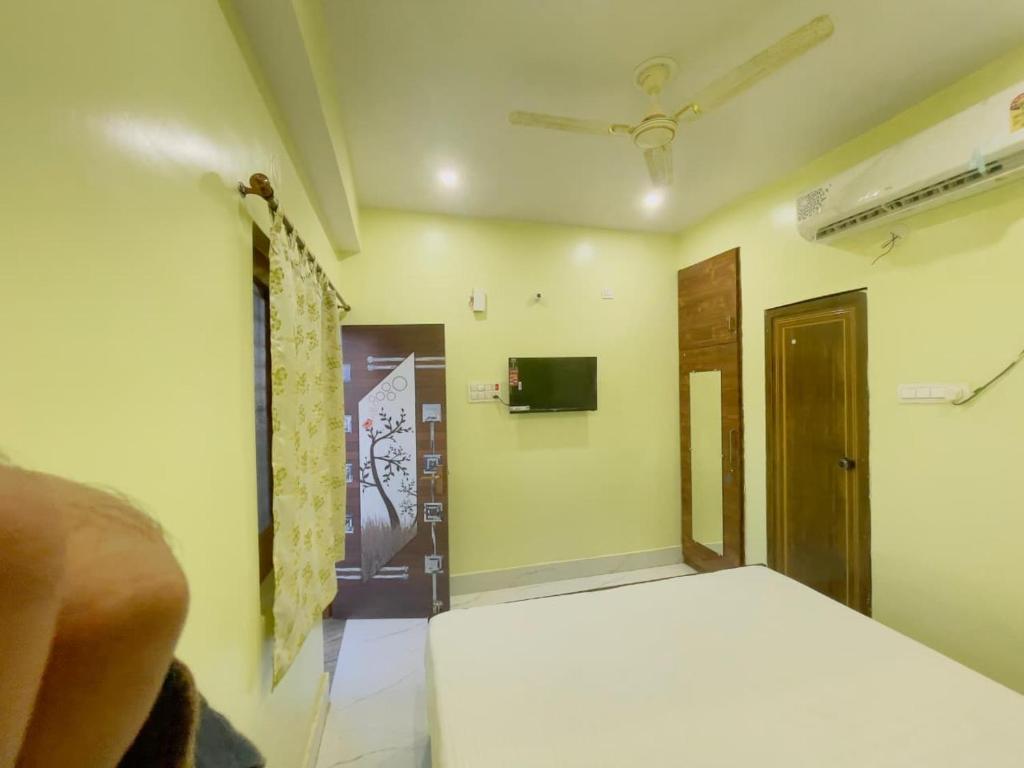 a bedroom with a white bed and a door at The Cruze - Premium Hotel in Gulzārbāgh