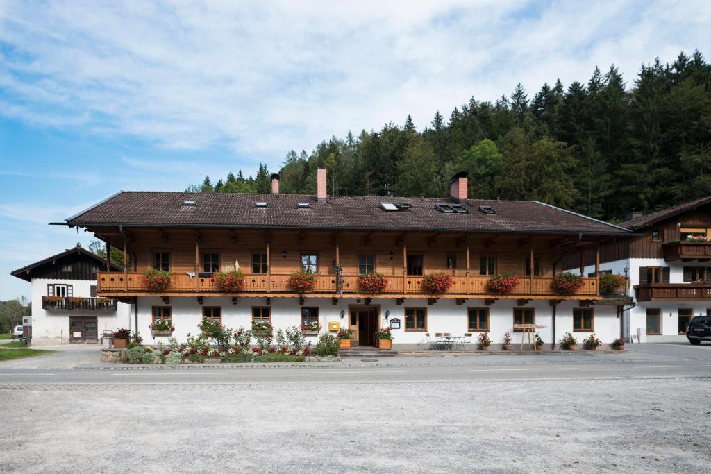 a large building with flowers in front of it at Gasthaus Posch in Miesbach