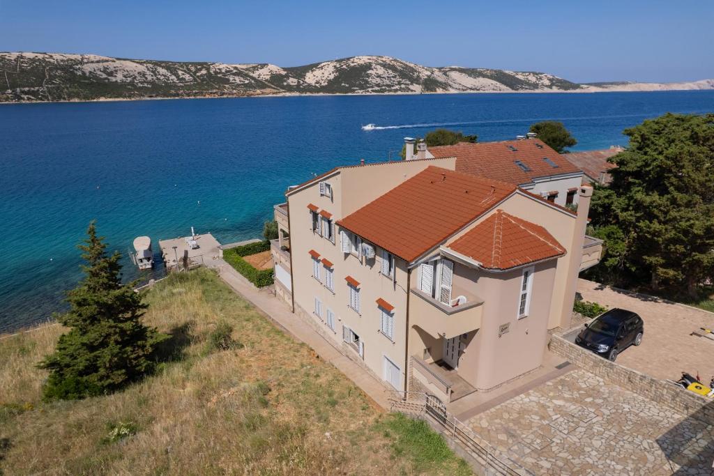 an aerial view of a house on the water at Apartmani Kaštel in Stara Novalja