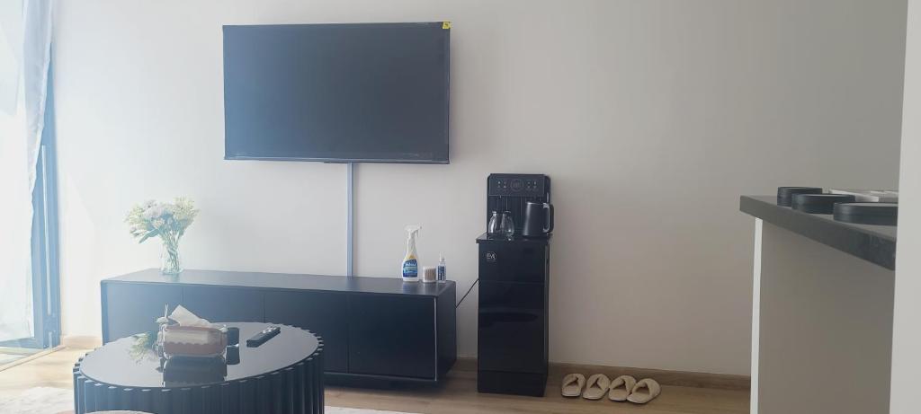 a living room with a television and a coffee table at Lace Luxe Homes in Tatu City