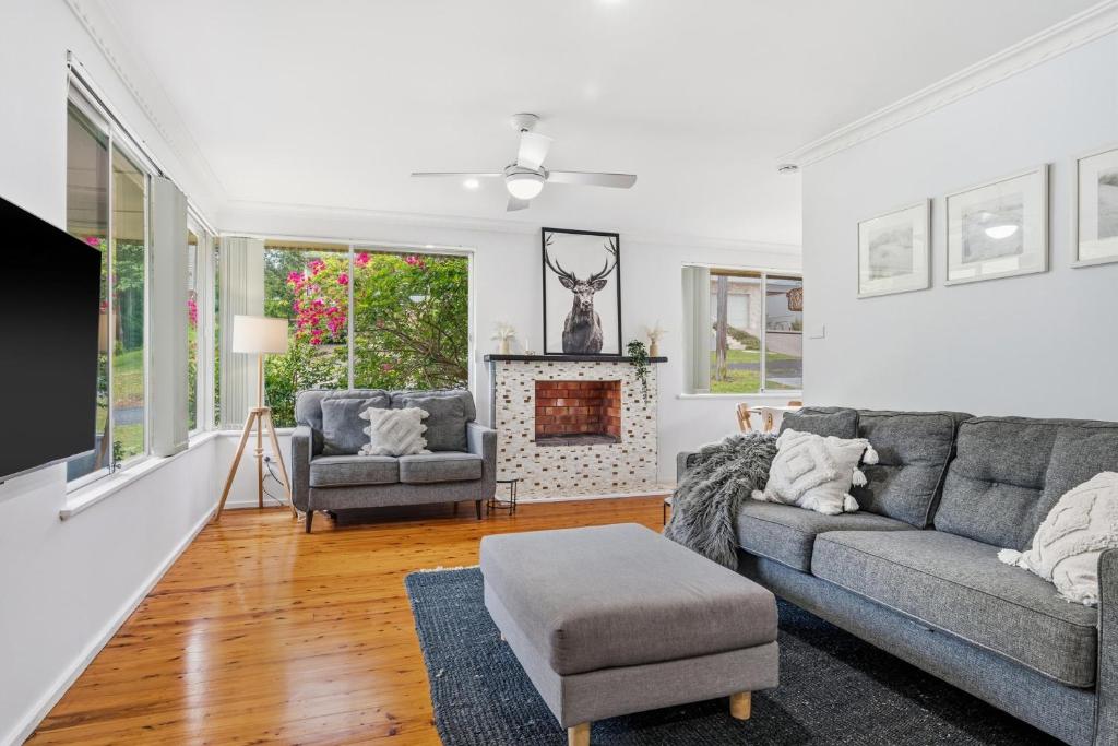 a living room with a couch and a fireplace at Salt & Sand - Flynn's Beach in Port Macquarie