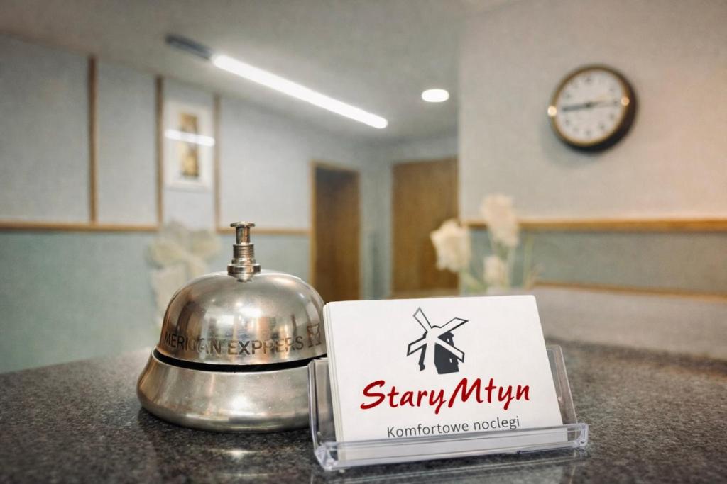 a sign sitting on top of a counter next to a bell at Stary Młyn in Żory