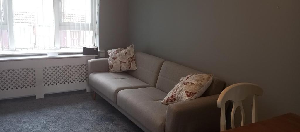 a living room with a couch and a window at Lilypad in Devizes