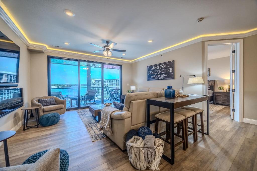 a living room with a couch and a table at Family Tides Condo for 8 in Osage Beach