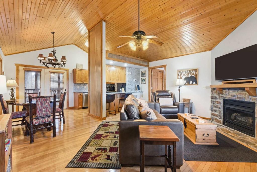 a living room with a couch and a fireplace at Blue Sky Lodge For 4 in Branson West