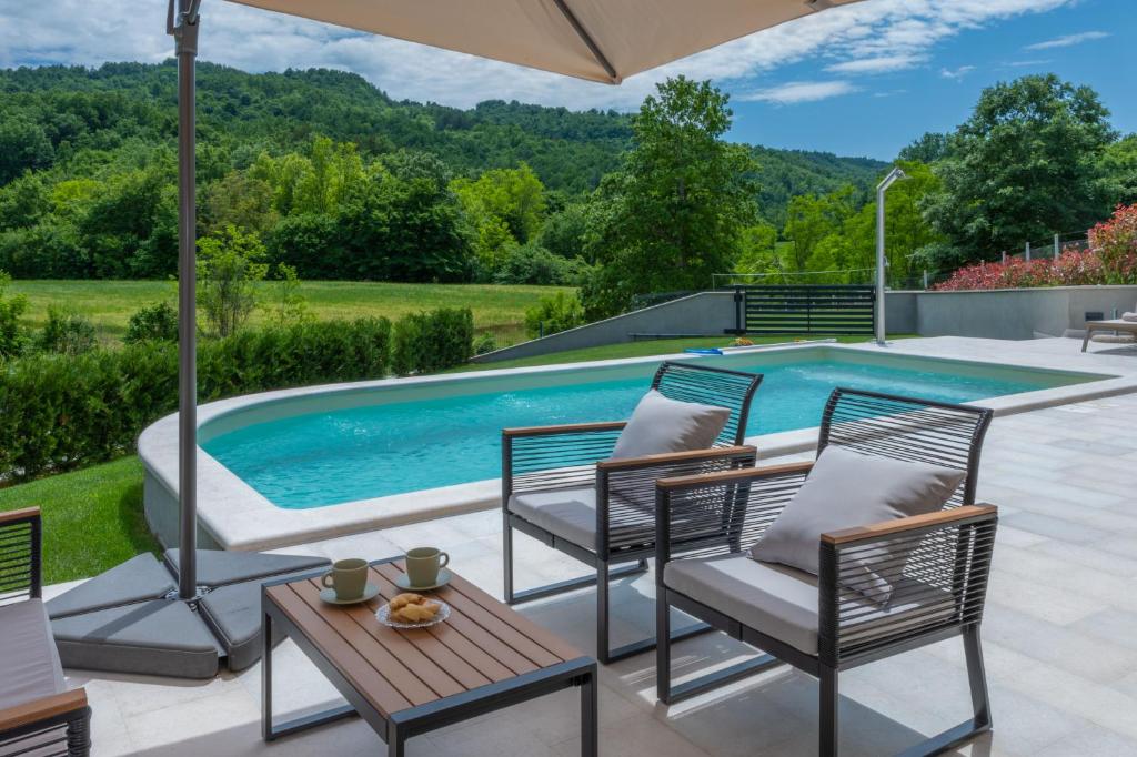 a patio with chairs and a swimming pool at Villa Gino in Pazin
