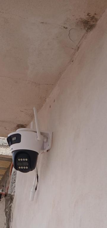 a security camera on the side of a wall at La Mejor-A in Comandante Luis Piedra Buena