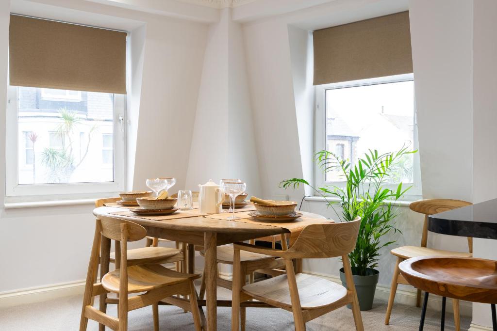 a dining room with a wooden table and chairs at 90A Tower Road in Newquay