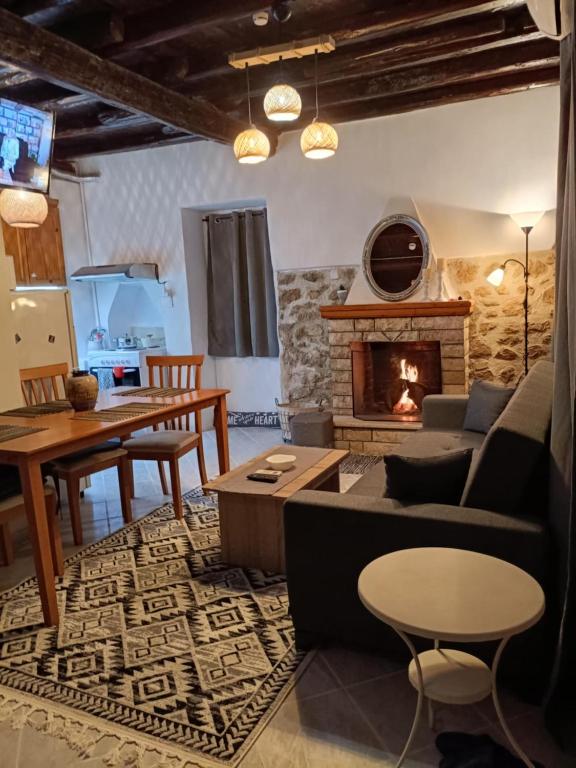 a living room with a couch and a fireplace at Aπανεμα Ανδ συγγρου 34 in Galaxidi