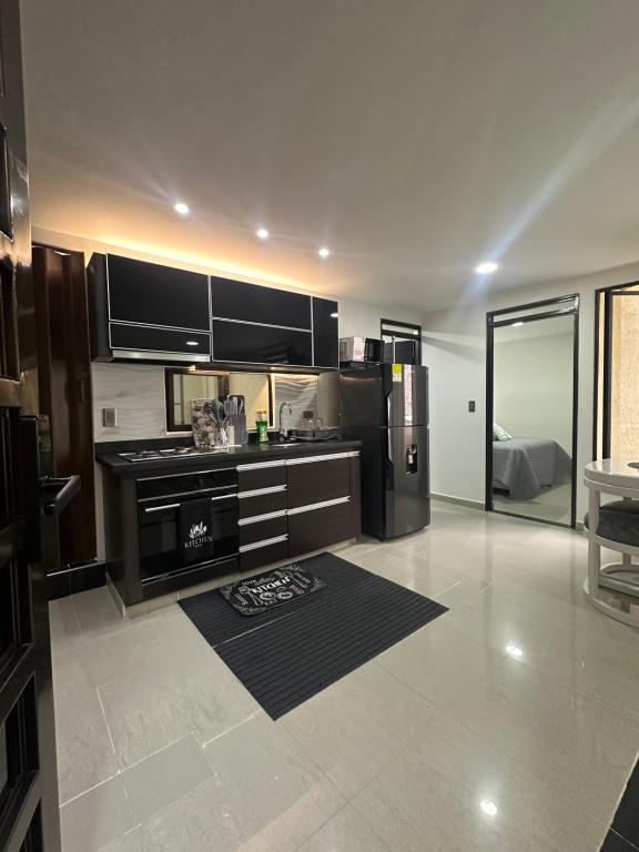 a kitchen with stainless steel appliances in a room at 202 Apartaestudio Edificio Natura 54, cercano Centro Comerciales in Ibagué