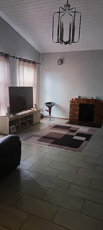 a living room with a flat screen tv and a couch at Accomodation in Cape Town in Goodwood