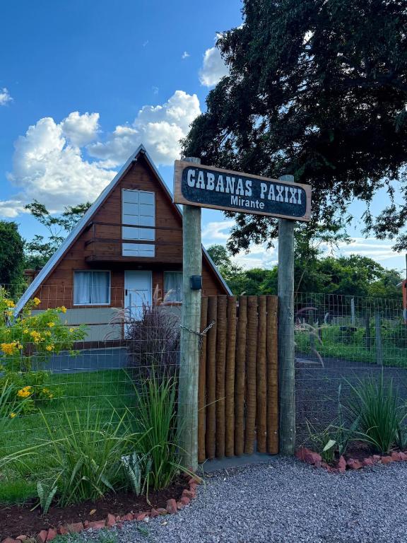 a sign in front of a house with a fence at Cabanas Paxixi - Mirante in Camisão
