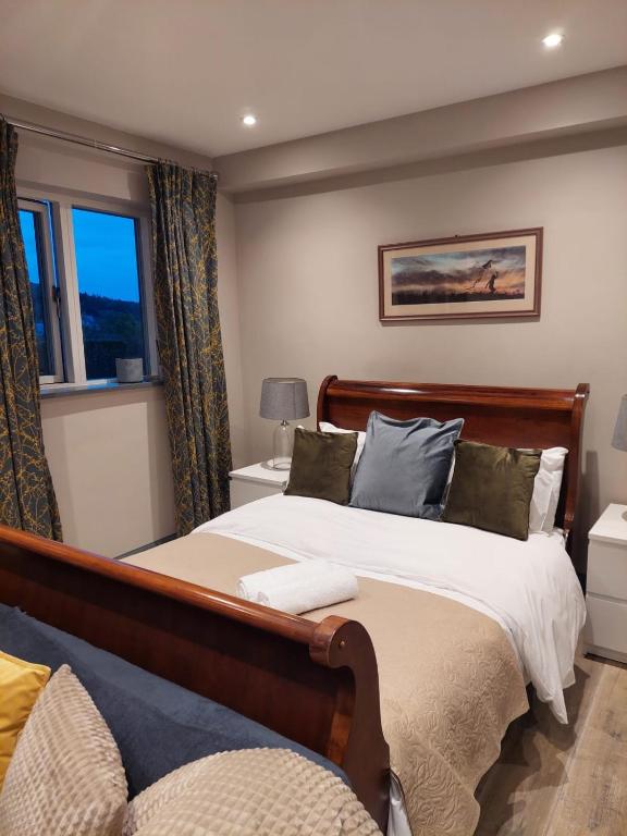 a bedroom with a large bed and two windows at The Snook-Free Parking-Near Pentland Hills in Loanhead