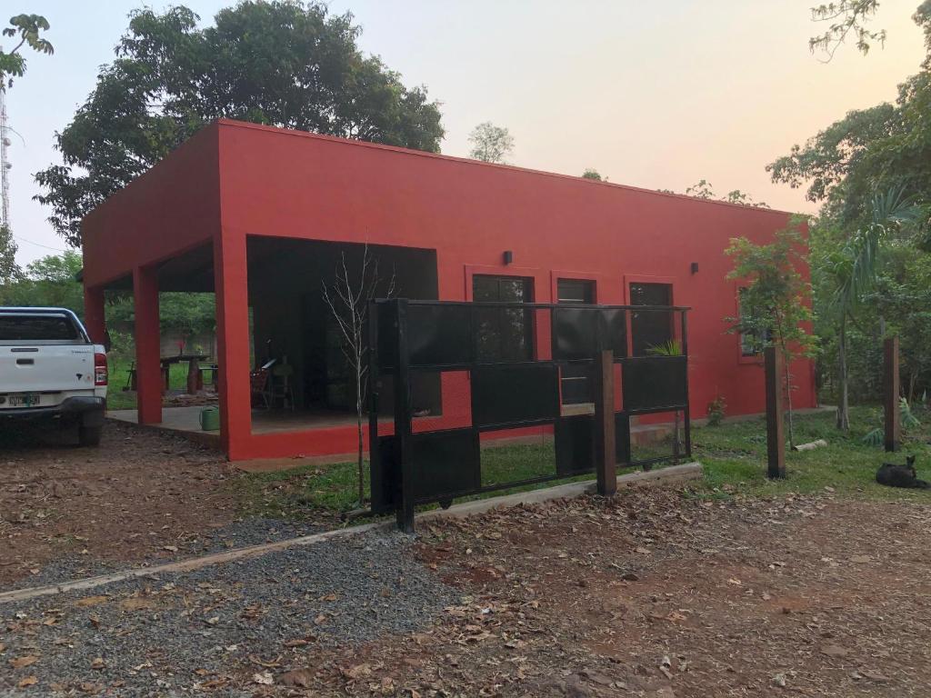 a red building with a truck parked in front of it at Casa roja in Eldorado