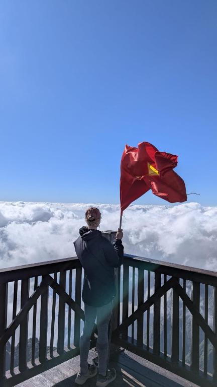 a person holding a flag on top of a fence at Beautiful Homestay Sapa in Sapa