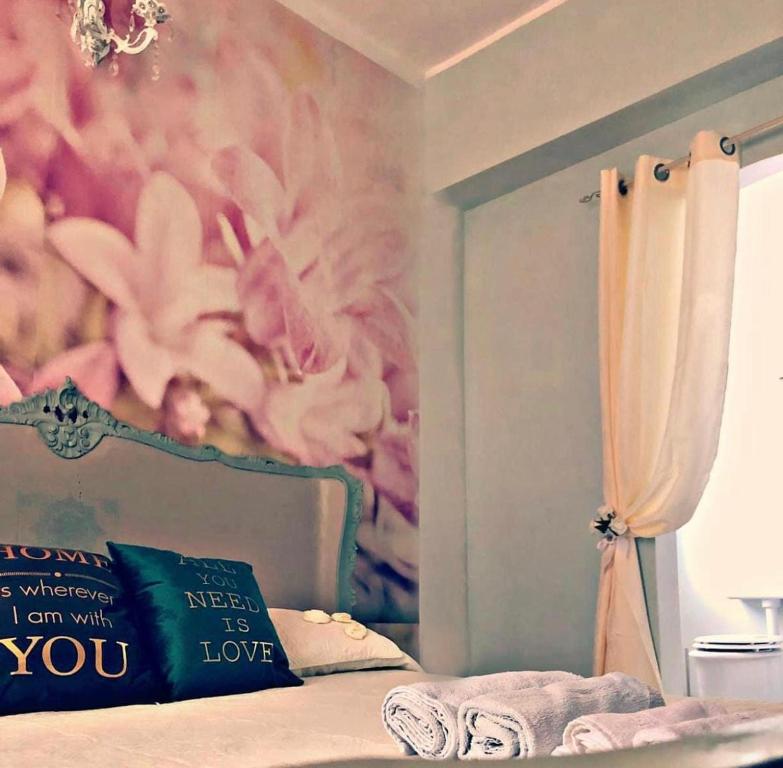 a bedroom with a bed with a flower mural at Love Gioia Tauro in Gioia Tauro