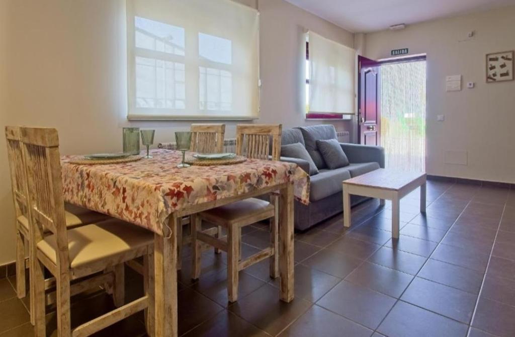 a living room with a table and a couch at Apartamentos turísticos Sardon in Sardón de los Frailes