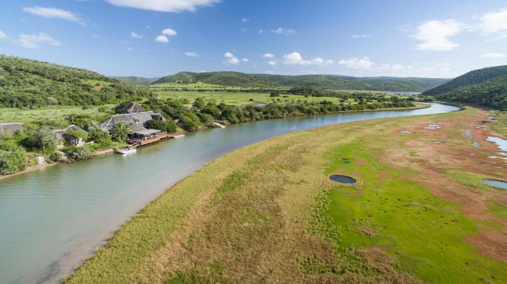 an aerial view of a river with hills in the background at Kariega Game Reserve River Lodge in Kenton on Sea