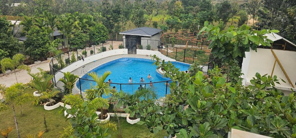 an overhead view of a swimming pool at a resort at Ambience Retreat in Malavalli