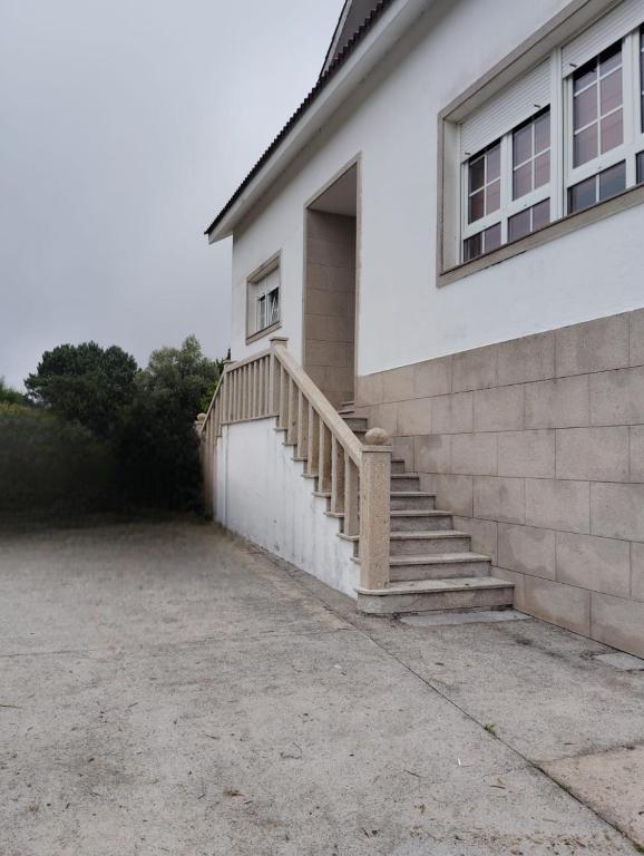 a house with stairs on the side of it at Agra Boa in Bornalle