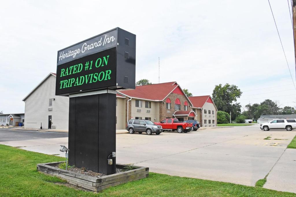 a sign in the grass in a parking lot at Heritage Grand Inn in Canton